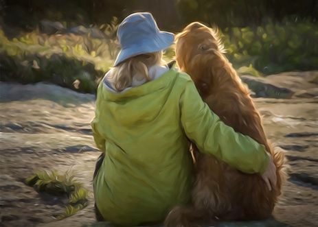 Woman outside sitting on ground with arm around golden retriever.